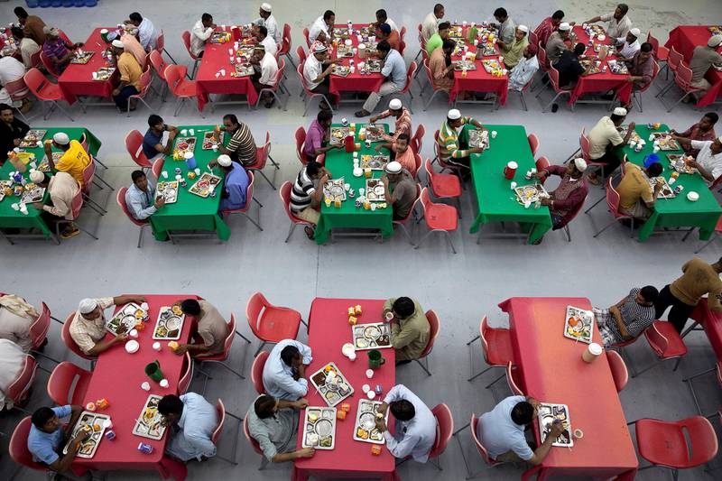 Abu Dhabi, United Arab Emirates, July 23, 2013   :   Men fill up the dining hall as they all join in to break their fast at Iftar on Tuesday evening, July 23, 2013, at the Saadiyat Accommodation Village on the Saadiyat Island in Abu Dhabi. About half of the men currently living at the workers' village are the Louvre Abu Dhabi joint venture employees. Many of them, about 60 percent of the workforce, fast for the entire duration of the Holy Month of Ramadan. 
Silvia Razgova / The National

Restricted!!!
Reporter: James Langton



 *** Local Caption ***  sr-130723-louvreramadan0609.jpg sr-130723-louvreramadan0609.jpg