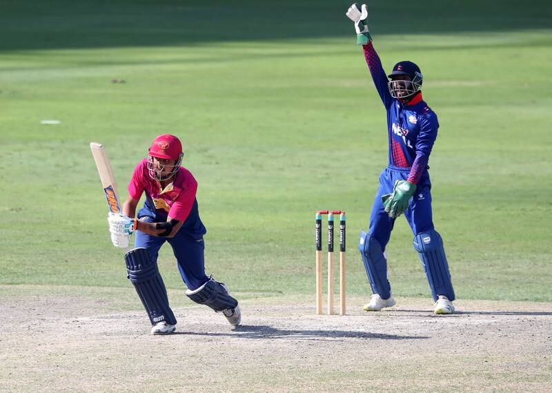Nepal's Dipendra Singh Airee takes the wicket of the UAE's Aryan Lakra.