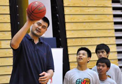 Former NBA player Yao Ming, left, of China takes part in a Special Olympics training camp in Taipei on June 14, 2014. Mandy Cheng / AFP