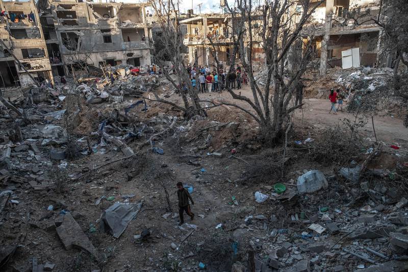 Palestinians gather amid the rubble of destroyed homes in Beit Hanoun, northern Gaza, on May 22, 2021. Getty