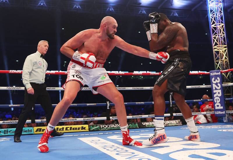 Tyson Fury lands a body punch on Dillian Whyte during the WBC world heavyweight title fight. Getty