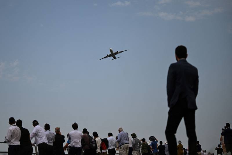 An Airbus A350 plane flying over the crowds at Farnborough. AFP