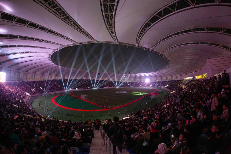 The Minaa Olympic Stadium at night.