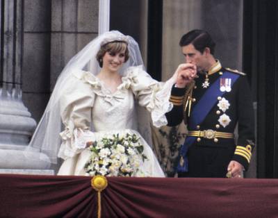 The Prince and Princess of Wales on the balcony of Buckingham Palace on their wedding day, 29th July 1981. Diana wears a wedding dress by David and Elizabeth Emmanuel and the Spencer family tiara. (Photo by Terry Fincher/Princess Diana Archive/Getty Images)