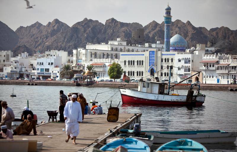 Backed by the white buildings that line the corniche of Mutrah district, fishermen and delivery staff work near the Mina Sultan Qaboos in downtown Muscat, the capital of the Sultanate of Oman on Wednesday, Oct. 12, 2011. (Silvia Razgova / The National)
