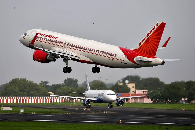 An Air India aircraft takes off as an IndiGo Airlines aircraft waits for clearance at the Sardar Vallabhbhai Patel International Airport in Ahmedabad, India, July 7, 2017. Picture taken July 7, 2017. To match Analysis AIR INDIA-PRIVATISATION/  REUTERS/Amit Dave - RC1DEE6C5CC0