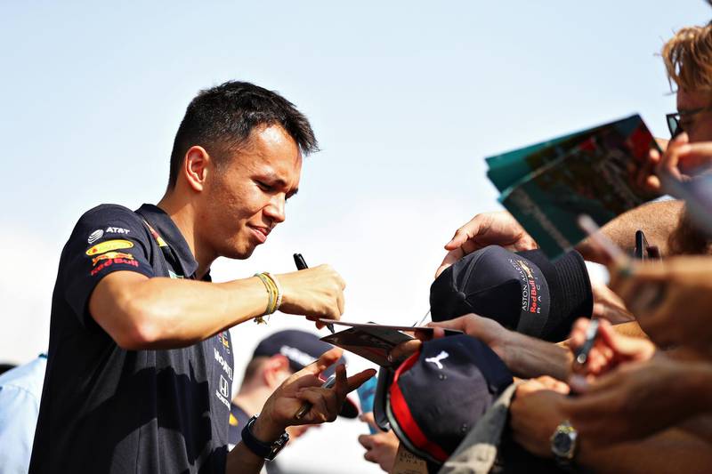 Alexander Albon of Thailand and Red Bull Racing signs autographs for fans before the F1 Grand Prix of Abu Dhabi at Yas Marina Circuit. Gett
