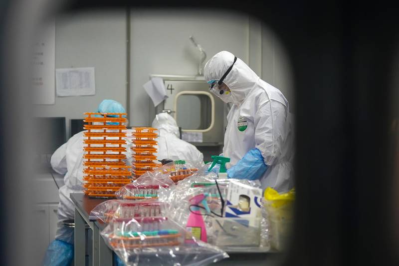 Medical workers in protective suits at a coronavirus detection lab in Wuhan in central China's Hubei Province.  AP