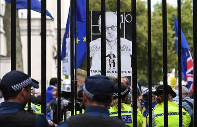 Police officers monitor Pro EU campaigners as they protest outside Downing Street. EPA