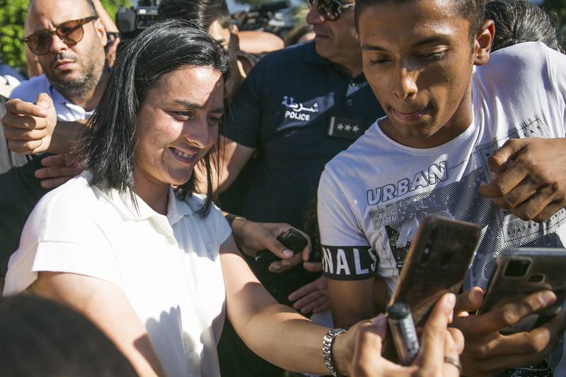 Jabeur poses for a selfie with fans as she arrives at Tunis airport. AP