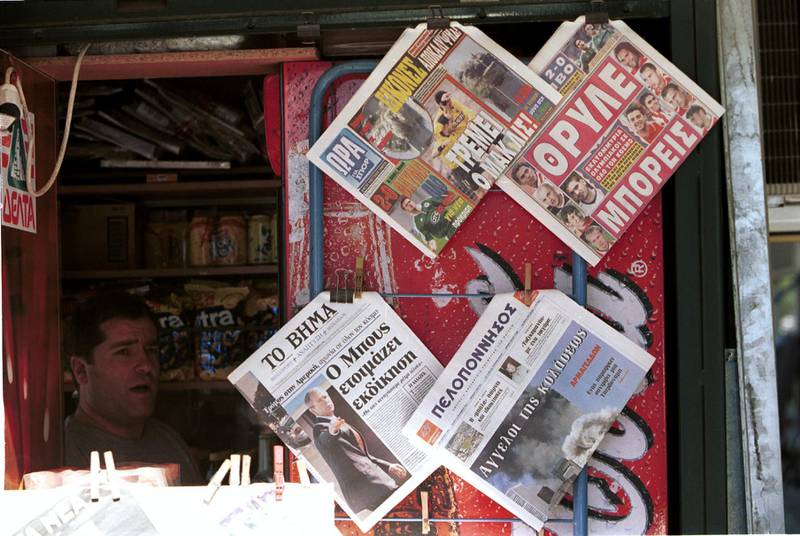 A Greek news stand in Athens with local sports papers previewing Olympiakos v Manchester United whilst the newspapers report the terrorist attack on the United States in September, 2001. Getty
