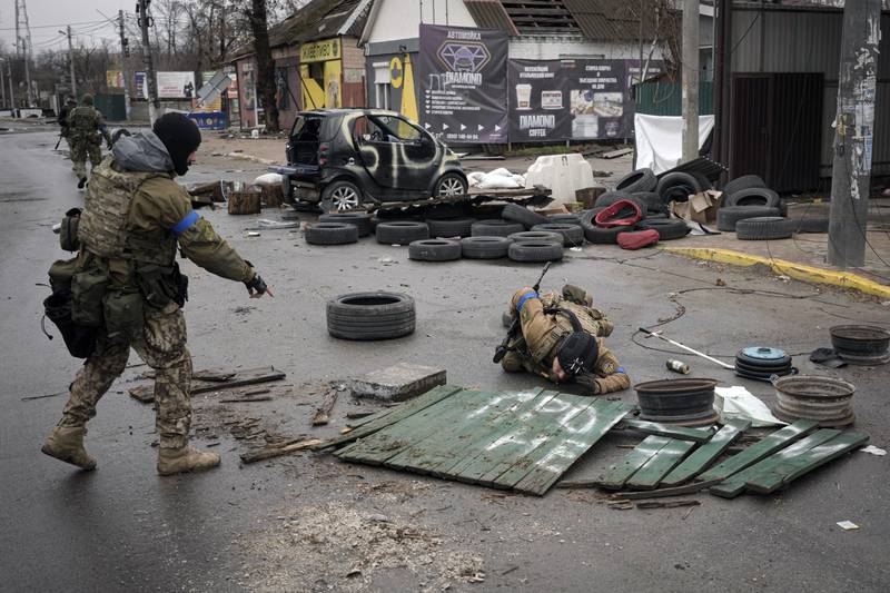 A Ukrainian soldier check streets for booby traps after Russian troops withdrew from Bucha. AP