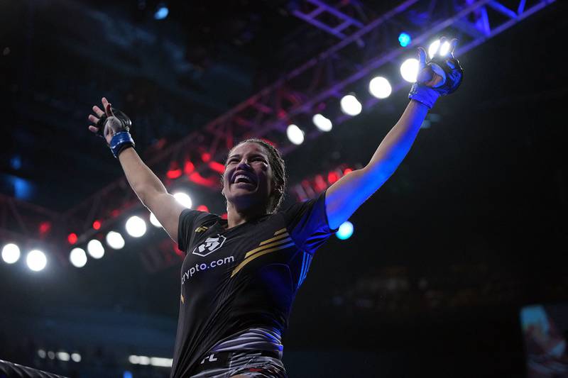 Julianna Pena celebrates her victory by submission against Amanda Nunes to claim the UFC women's bantamweight title. Reuters