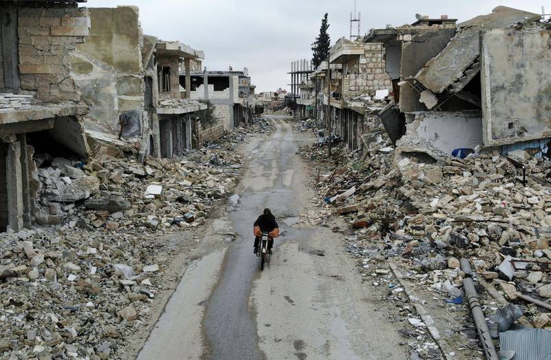 An aerial picture taken on February 15, 2020, shows a Syrian man on a motorbike in the deserted Syrian city of Kafranbel. AFP