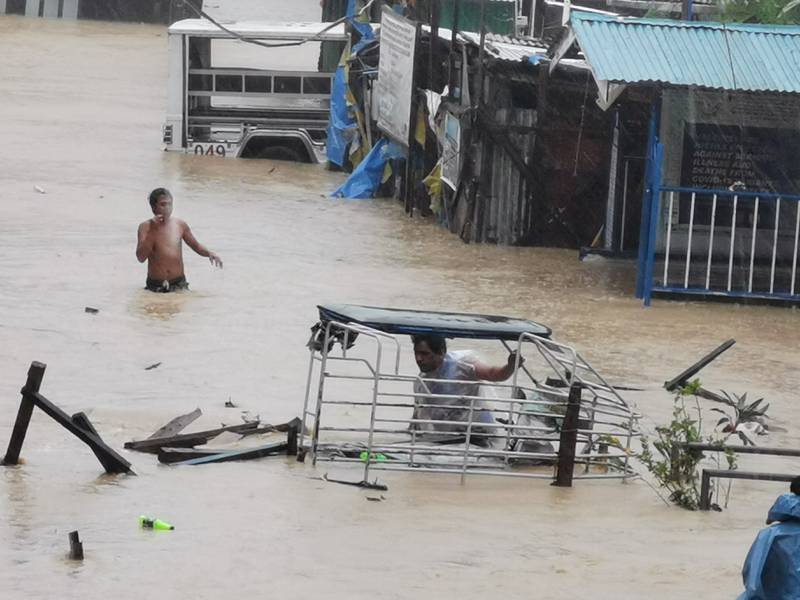 Wading through floodwaters in Boac, Marinduque Province. Reuters