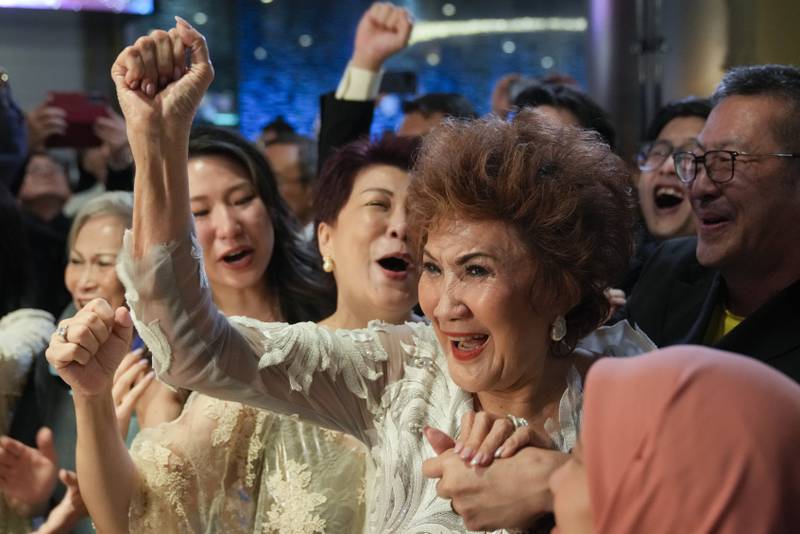 Janet Yeoh, Michelle Yeoh's mother, celebrates after her daughter won in the best actress category during the 95th Academy Awards in Los Angeles, as seen in a live view event at a cinema in Kuala Lumpur. AP