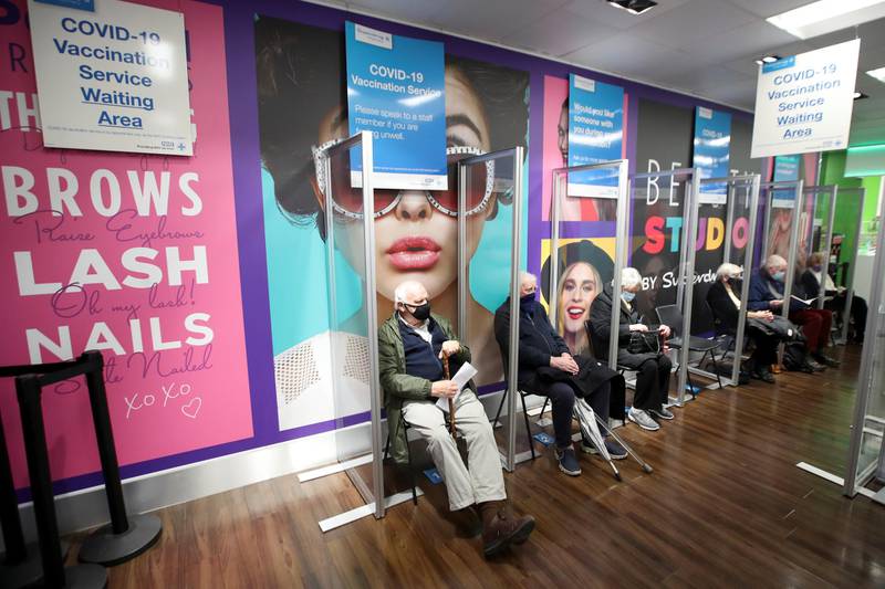 People wait to receive the Oxford/AstraZeneca vaccine at a Superdrug pharmacy in Guildford. Reuters
