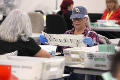 Election workers open mail-in ballots at the Maricopa County Tabulation and Election Centre in Phoenix, Arizona. AFP