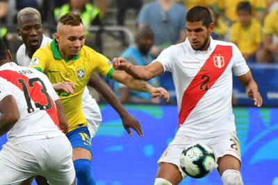 Brazil's Everton Soares, left, and Peru's Luis Abram vie for the ball. AFP