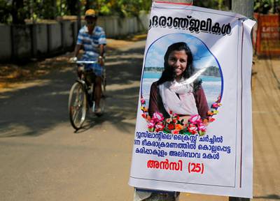 A man pedals his bicycle past a poster of Anzi Ali Bhava, who was killed in Friday's mosque attacks in New Zealand, in Kodungalloor town in the southern state of Kerala, India, March 17, 2019. The words on the poster read: "Condolence to Anzi, 25, daughter of Karipakulam Ali Bhava killed in a terrorist attack in Christchurch, New Zealand". REUTERS/Sivaram V