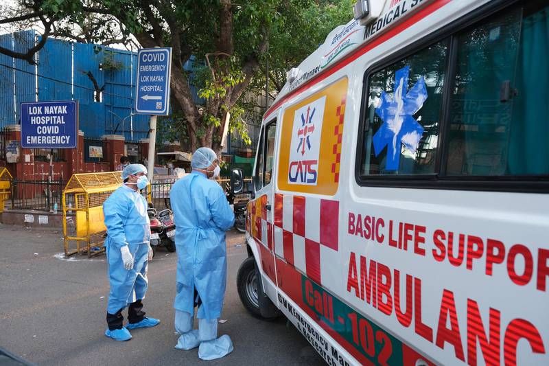 Health workers turn away an ambulance at the main entrance of Lok Nayak Jaiprakash Hospital in India's capital New Delhi. Bloomberg