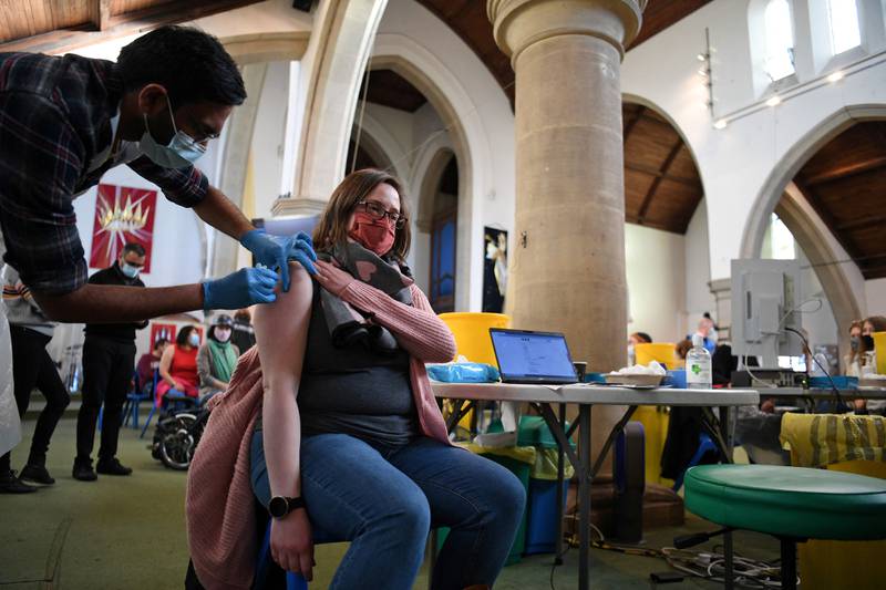 A member of the public receives a Covid-19 Moderna booster vaccine jab at a temporary vaccination centre set up inside St John's Church in west London. AFP