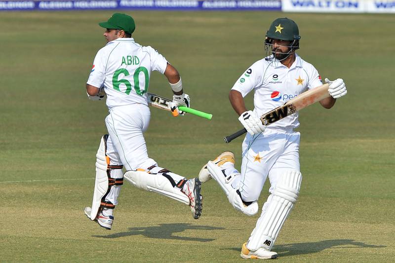 Abid Ali and Abdullah Shafique run between the wickets on the second day of the first Test between Bangladesh and Pakistan. AFP