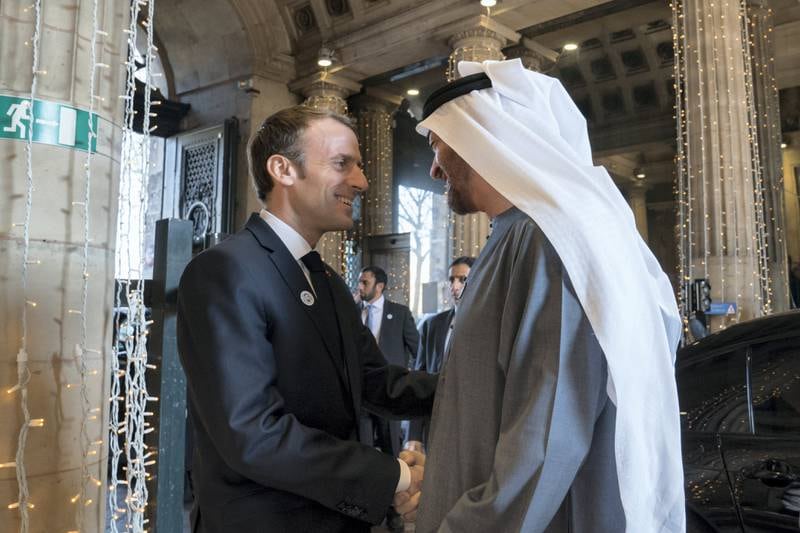 A picture posted on Sheikh Mohamed's Twitter page shows him and Mr Macron embracing, with the French leader wearing a Year of Zayed pin.