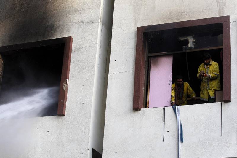 Firefighters put out a blaze near the residence of Yemeni ex-president Ali Abdullah Saleh.  Yayha Arhab / EPA