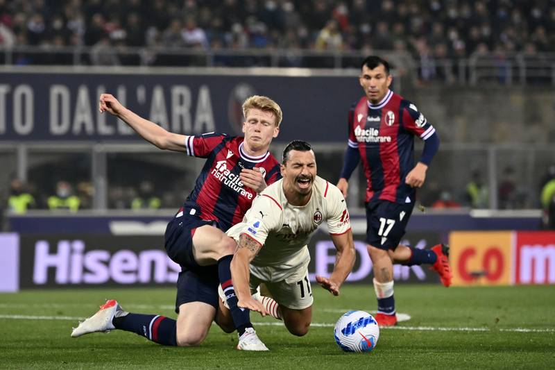 AC Milan's Zlatan Ibrahimovic goes down under a challenge from Bologna's Jerdy Schouten during the Serie A match at Renato Dall'Ara stadium in Bologna, Italy, Saturday, October 23, 2021. AP
