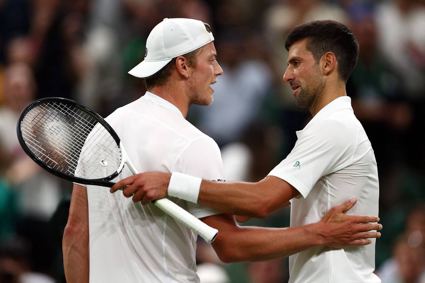 Serbia's Novak Djokovic, right, with the Netherlands' Tim van Rijthoven after their match at Wimbledon on Sunday. AFP