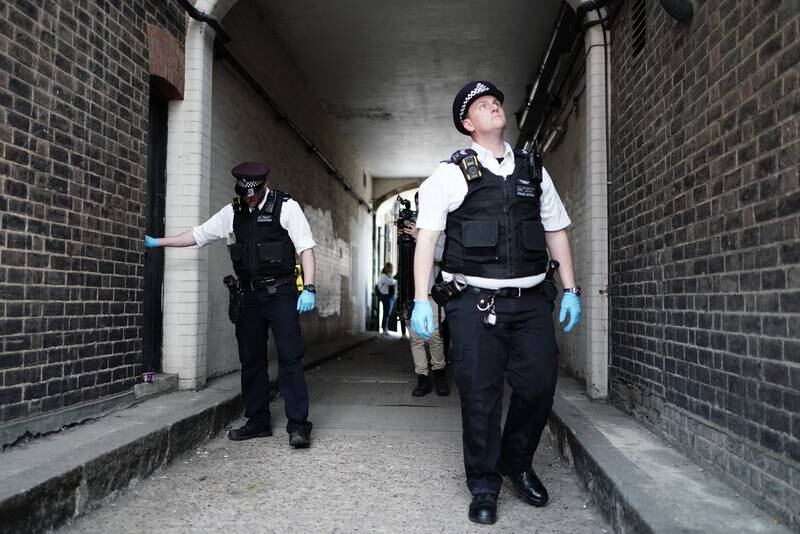 Police officers during a weapons sweep to tackle knife crime in London. PA