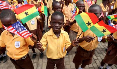 Children carry flags as they greet Melania Trump in Accra, Ghana. Reuters