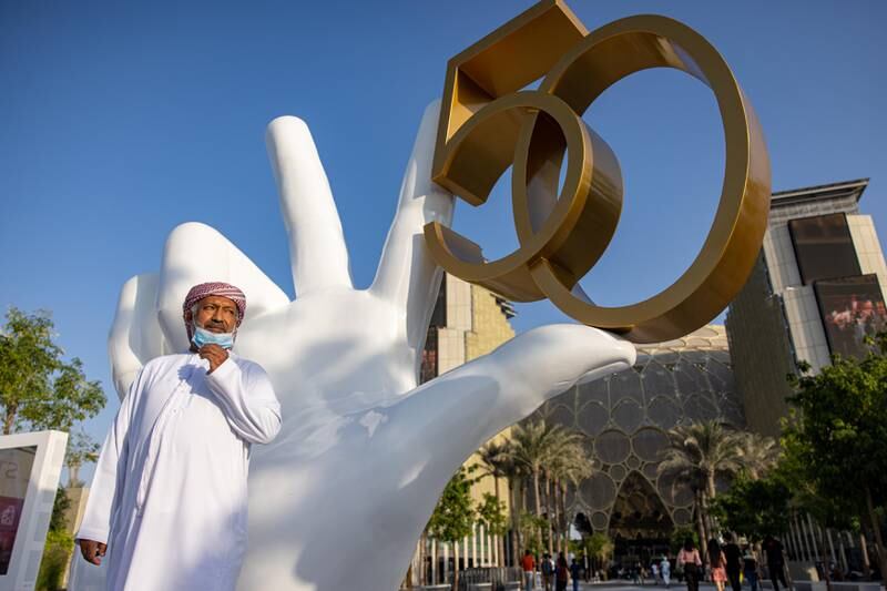 Visitor poses for a picture beside the installation in celebration of the UAE's 50th National Day. Image: Expo 2020 Dubai