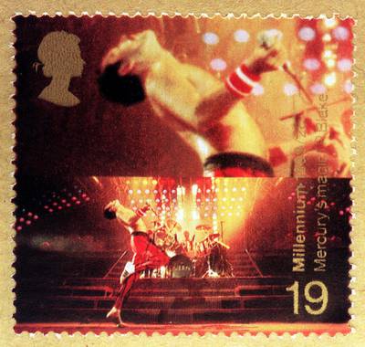 This stamp featuring the rock singer Fredie Mercury was at the centre of a fresh controversy when it was revealed Wednesday  June 3, 1999, that it breaches Royal Mail rules that no living person - other than members of the Royal family - may appear on a British postage stamp.  Roger Taylor, the drummer of the rock band Queen, is clearly visible behind Freddie Mercury on the 19p stamp.  The Royal Mail admitted it was a rare breach of the rule, but called for  common sense to prevail  over the pinhead-sized portrait.   See PA story ROYAL Stamp   (Photo by PA Images via Getty Images)