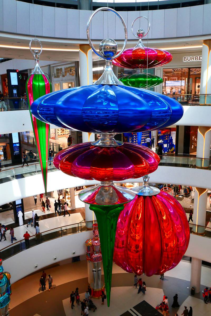 Hanging Christmas decorations at The Dubai Mall. Pawan Singh / The National