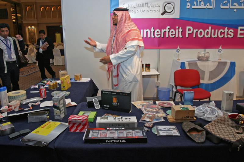 DUBAI, UNITED ARAB EMIRATES - February 4:  Faisal A. Bin Othaimin, Executive Committee Member, Public Relations, Hemaya Universal, showing some of the counterfeit goods on display at his stand during the 4th Global Conference on Combating Counterfeiting & Piracy, held at the Madinat Jumeirah Conference Hall, Dubai, on February 4, 2008, (Photo by Randi Sokoloff / ADMC)
