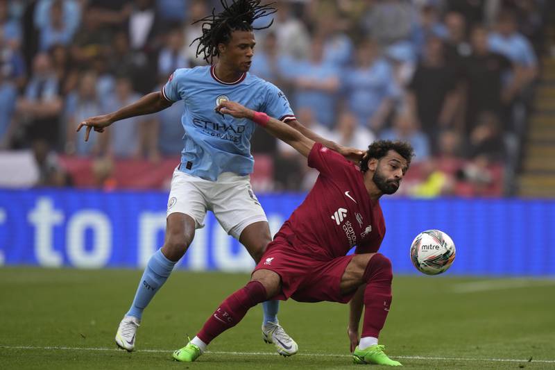 Liverpool's Mohamed Salah, right, is challenged by Manchester City's Nathan Ake. AP