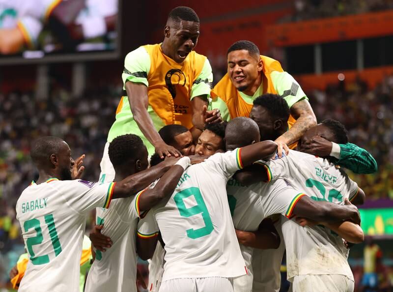 Senegal's Kalidou Koulibaly celebrates with teammates after scoring their second goal in the 2-1 Group A win against  Ecuador at Khalifa International Stadium on November 29, 2022, in Doha. Getty