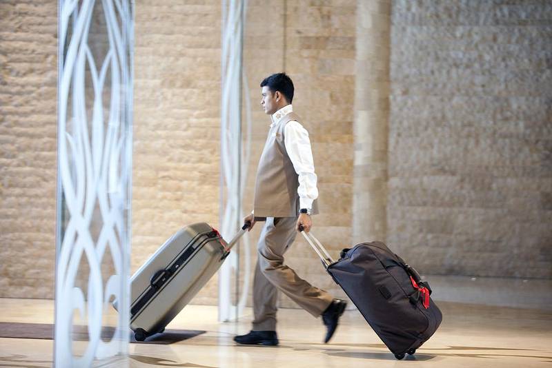   A porter hurries suitcases thought the lobby at the Sofitel The Palm hotel at the Palm Jumeirah in Dubai. Strong hotel bookings for the festive period have been recorded. Silvia Razgova / The National







