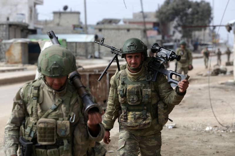 Turkish troops patrol in the town of Atareb in the rebel-held western countryside of Syria's Aleppo province on February 19, 2020.
 Turkey and Russia were engaged in a fresh war of words today after President Recep Tayyip Erdogan threatened an "imminent" operation in Syria to end the regime's brutal assault on the last rebel enclave. It came as Syrian aid workers issued an urgent call for a ceasefire and international help for nearly a million people fleeing the regime onslaught in the country's northwestern Idlib province -- the biggest wave of displaced civilians in the nine-year conflict. / AFP / Aref TAMMAWI
