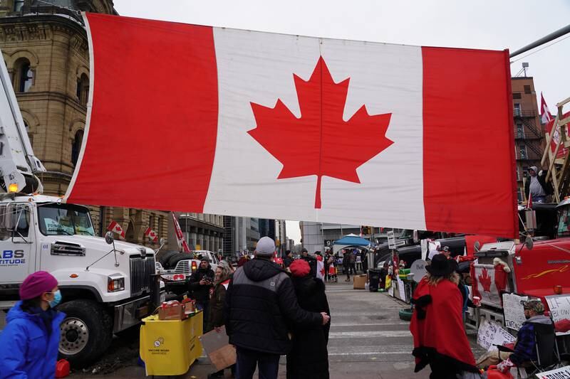 A giant Canadian flag hangs at an intersection near the Parliament. Willy Lowry / The National