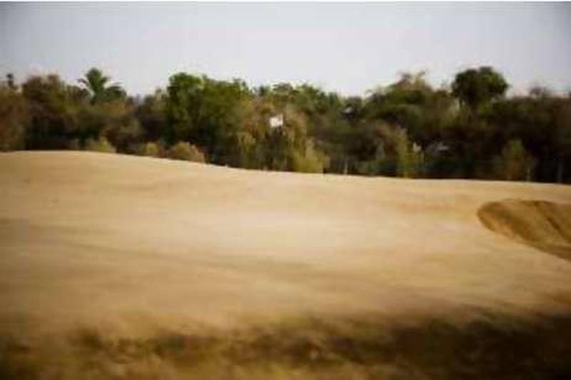 Abu Dhabi - June 12, 2008: The twelvth hole at Al Ghaza sand golf course. Al Ghaza is located near the Abu Dhabi Airport . Lauren Lancaster / The National  *** Local Caption ***  LL_SandGolf006.jpg