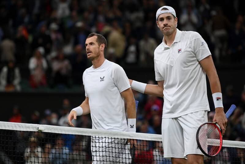 John Isner of the United States, right, consoles Andy Murray of Great Britain after winning their second-round match at Wimbledon 2022. Getty Images