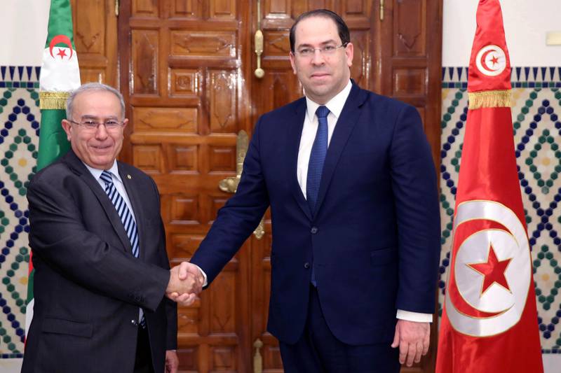 Tunisian Prime Minister Youssef Chahed, right, shakes hands with Algeria's Vice Prime Minister Ramtane Lamamra, in Carthage. AP Photo