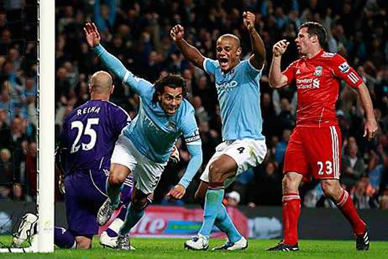 Manchester City's Carlos Tevez celebrates scoring against Liverpool in 2010. PA