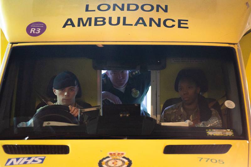 Armed forces personnel drive an ambulance as paramedics, ambulance technicians and call handlers strike in England and Wales. PA