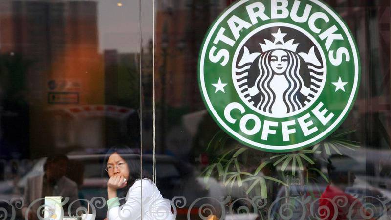 A customer looks out the window of a Starbucks coffee shop in Beijing. The Seattle-based coffee chain is banking on China growth to offset a cooling US market. Raul Vasquez / Bloomberg News
