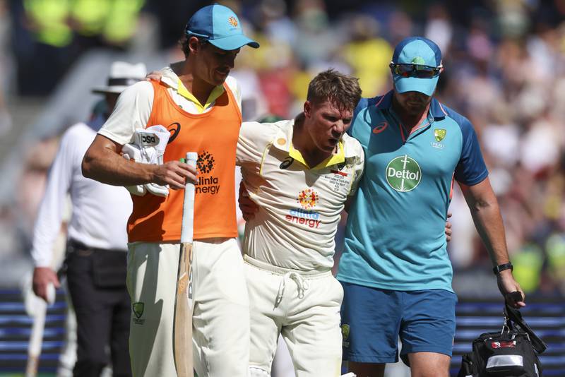 David Warner is assisted from the field as he retires injured after reaching 200 runs. AP