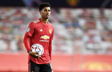 epa08782011 Marcus Rashford of Manchester United walks off with the match ball after scoring a hattrick in the UEFA Champions League group H match Manchester United vs RB Leipzig in Manchester, Britain 28 October 2020. Manchester United won 5-0. EPA/Peter Powell